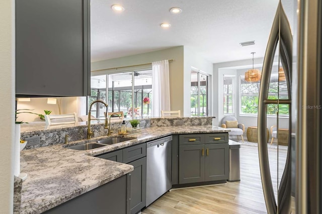 7725 235th St E, Myakka City, FL 34251 - kitchen featuring stainless steel appliances, light wood finished floors, recessed lighting, a peninsula, and gray cabinets