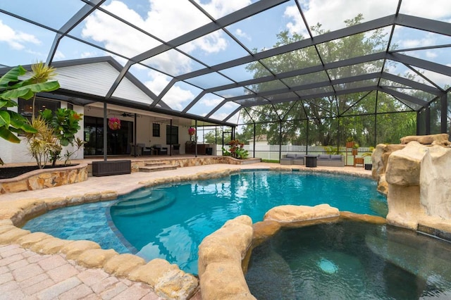 7725 235th St E, Myakka City, FL 34251 - view of swimming pool with outdoor lounge area, a patio, a pool with connected hot tub, ceiling fan, and a lanai