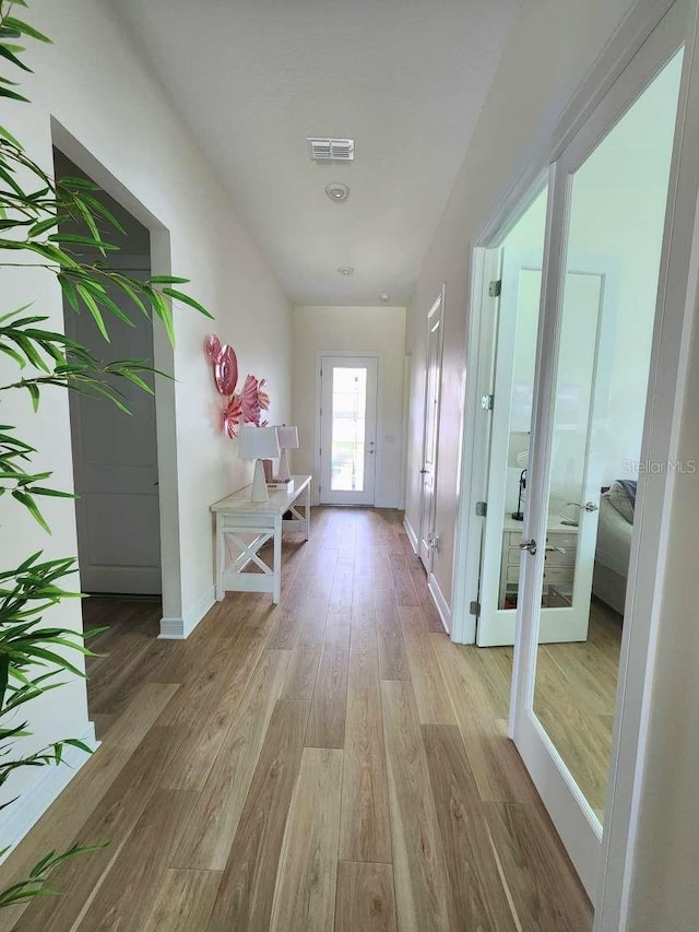 9024 Barrier Coast Trl, Parrish, FL 34219 - corridor with light wood-type flooring and french doors