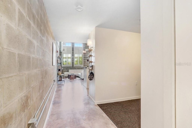 2001 E 2nd Ave Unit 37, Tampa, FL 33605 - corridor with concrete floors and concrete block wall