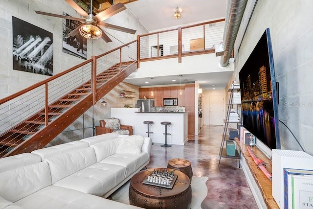 2001 E 2nd Ave Unit 37, Tampa, FL 33605 - living area with a high ceiling, finished concrete floors, stairway, and a ceiling fan