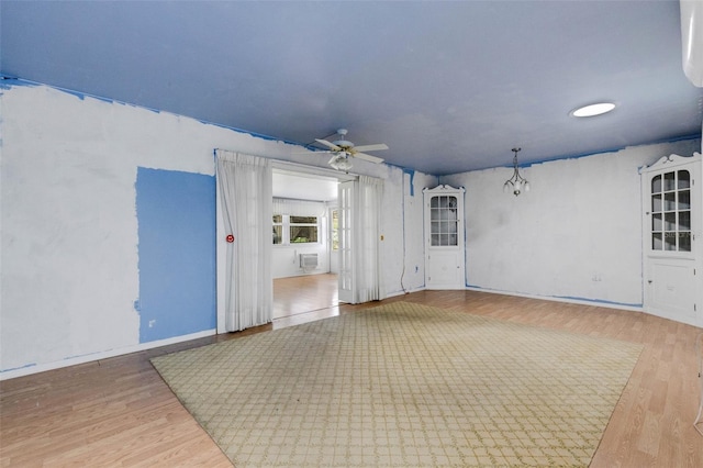 638 La Jolla Ave, Sun City Center, FL 33573 - empty room featuring wood finished floors, ceiling fan, and an AC wall unit