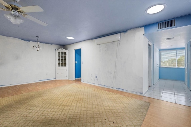 638 La Jolla Ave, Sun City Center, FL 33573 - unfurnished room featuring a wall mounted air conditioner, a ceiling fan, wood finished floors, and recessed lighting