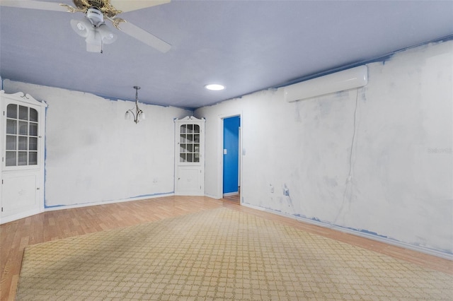 638 La Jolla Ave, Sun City Center, FL 33573 - spare room with wood finished floors, a ceiling fan, and a wall mounted AC
