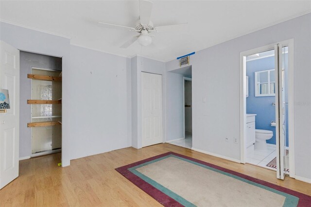638 La Jolla Ave, Sun City Center, FL 33573 - unfurnished bedroom with wood finished floors, ornamental molding, and ensuite bathroom