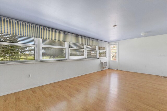 638 La Jolla Ave, Sun City Center, FL 33573 - unfurnished room featuring wood finished floors and an AC wall unit