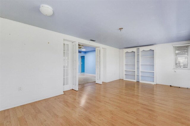 638 La Jolla Ave, Sun City Center, FL 33573 - spare room featuring french doors, wood finished floors, and a pendent fire sprinkler