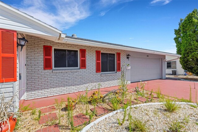 638 La Jolla Ave, Sun City Center, FL 33573 - view of front of house with brick siding, an attached garage, and concrete driveway