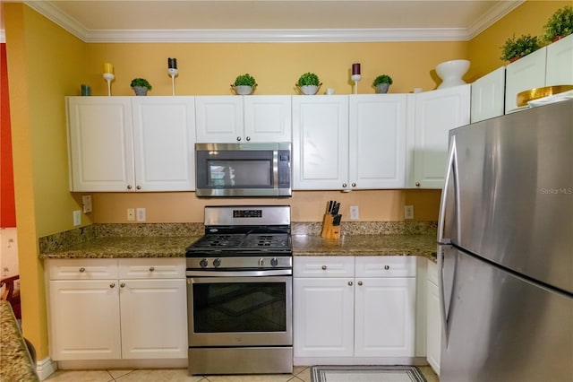 2724 Via Murano Unit 639, Clearwater, FL 33764 - kitchen with stainless steel appliances, crown molding, white cabinets, and light tile patterned floors