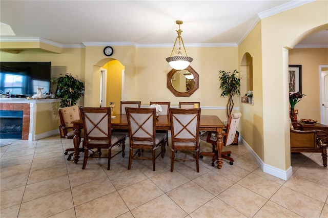 2724 Via Murano Unit 639, Clearwater, FL 33764 - dining area with ornamental molding, light tile patterned floors, arched walkways, and a fireplace