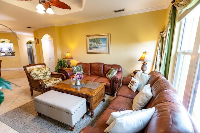 2724 Via Murano Unit 639, Clearwater, FL 33764 - tiled living room featuring arched walkways, a ceiling fan, and ornamental molding