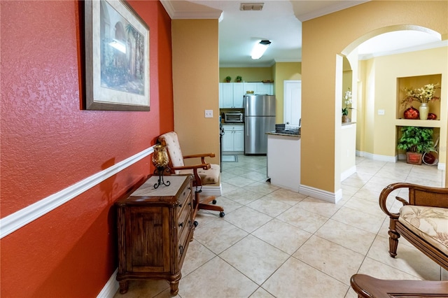 2724 Via Murano Unit 639, Clearwater, FL 33764 - hallway featuring crown molding, arched walkways, and light tile patterned floors