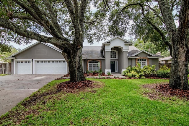 18004 Clear Lake Dr, Lutz, FL 33548 - view of front of property featuring stucco siding, concrete driveway, and an attached garage