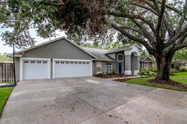 18004 Clear Lake Dr, Lutz, FL 33548 - single story home with stucco siding, driveway, and an attached garage