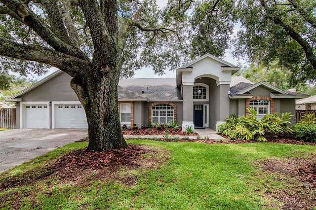 18004 Clear Lake Dr, Lutz, FL 33548 - view of front of house featuring stucco siding, driveway, a garage, and a shingled roof