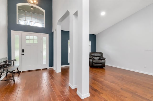 18004 Clear Lake Dr, Lutz, FL 33548 - foyer featuring a towering ceiling, hardwood / wood-style floors, and arched walkways