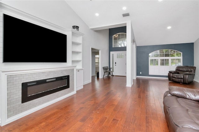 18004 Clear Lake Dr, Lutz, FL 33548 - living area featuring a fireplace, high vaulted ceiling, wood finished floors, and recessed lighting