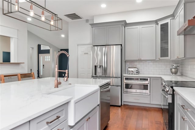 18004 Clear Lake Dr, Lutz, FL 33548 - kitchen featuring stainless steel appliances, gray cabinets, decorative backsplash, recessed lighting, and glass insert cabinets