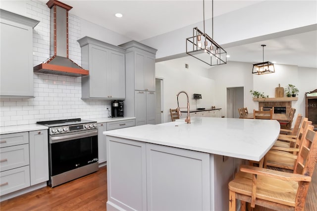 18004 Clear Lake Dr, Lutz, FL 33548 - kitchen with stainless steel electric stove, wall chimney range hood, gray cabinetry, tasteful backsplash, and recessed lighting