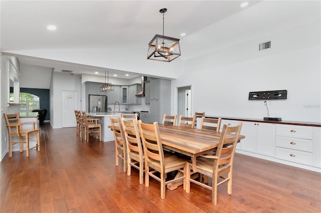 18004 Clear Lake Dr, Lutz, FL 33548 - dining area with vaulted ceiling, a chandelier, recessed lighting, and dark wood-style floors