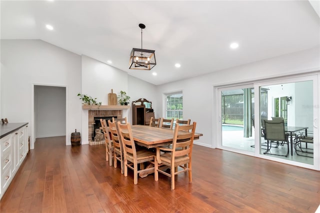 18004 Clear Lake Dr, Lutz, FL 33548 - dining room with dark wood-type flooring, a brick fireplace, recessed lighting, and high vaulted ceiling
