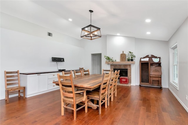 18004 Clear Lake Dr, Lutz, FL 33548 - dining area featuring dark wood-style flooring, recessed lighting, and a brick fireplace