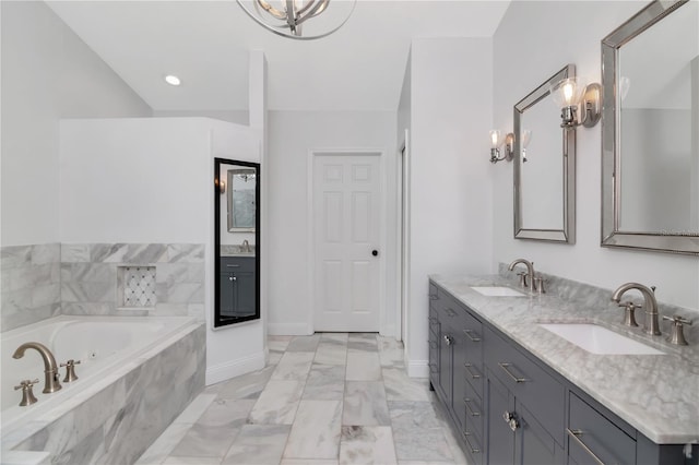 18004 Clear Lake Dr, Lutz, FL 33548 - bathroom featuring double vanity, a bath, a chandelier, and marble finish floors