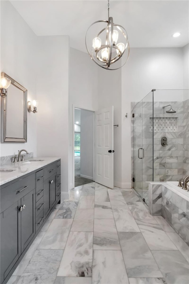 18004 Clear Lake Dr, Lutz, FL 33548 - full bathroom featuring a chandelier, a stall shower, marble look tiles, vanity, and a tub with marble appearance