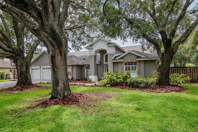 18004 Clear Lake Dr, Lutz, FL 33548 - view of front facade featuring stucco siding, driveway, and a garage