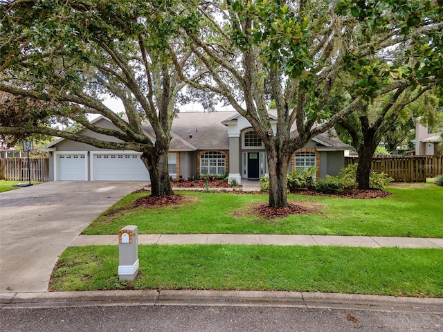 18004 Clear Lake Dr, Lutz, FL 33548 - view of front of home with stucco siding, driveway, an attached garage, and a shingled roof