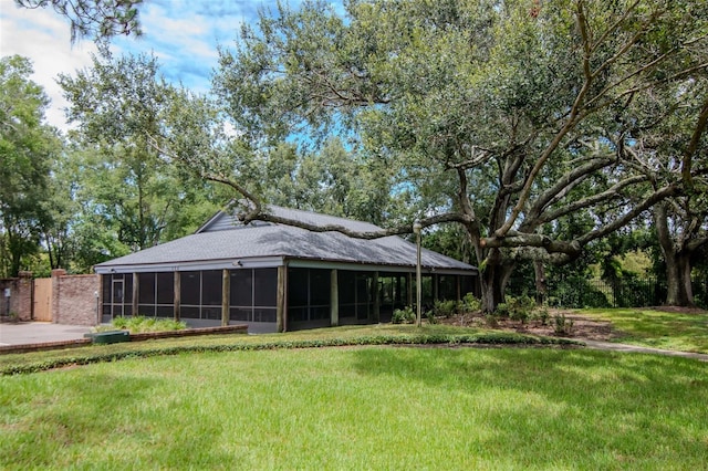 18004 Clear Lake Dr, Lutz, FL 33548 - rear view of house with a sunroom and a yard