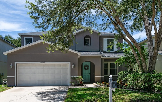 10605 Marsanne Pl, Riverview, FL 33578 - traditional-style house with stucco siding, driveway, a garage, and roof with shingles