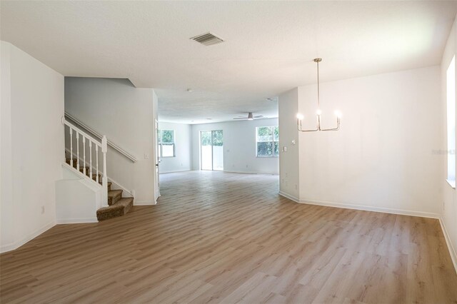 10605 Marsanne Pl, Riverview, FL 33578 - unfurnished living room with light wood-type flooring, stairs, and a ceiling fan