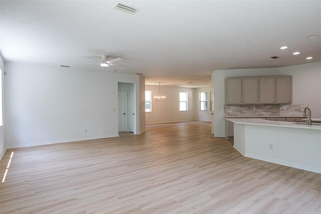 10605 Marsanne Pl, Riverview, FL 33578 - unfurnished living room featuring light wood-type flooring, a chandelier, recessed lighting, and a ceiling fan