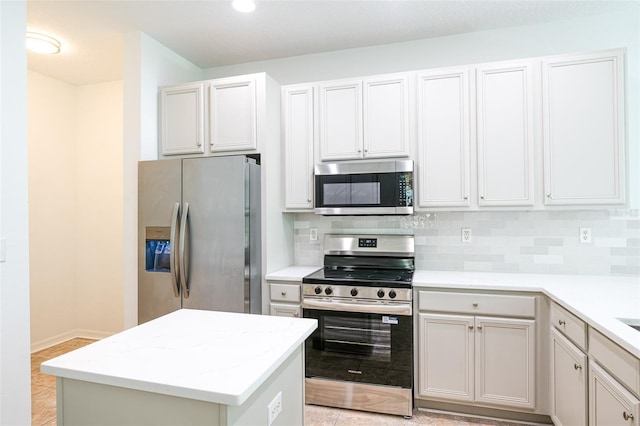 10605 Marsanne Pl, Riverview, FL 33578 - kitchen featuring appliances with stainless steel finishes, tasteful backsplash, a center island, recessed lighting, and light tile patterned flooring