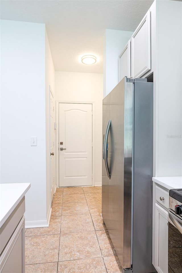 10605 Marsanne Pl, Riverview, FL 33578 - kitchen featuring stainless steel appliances, light countertops, and light tile patterned flooring