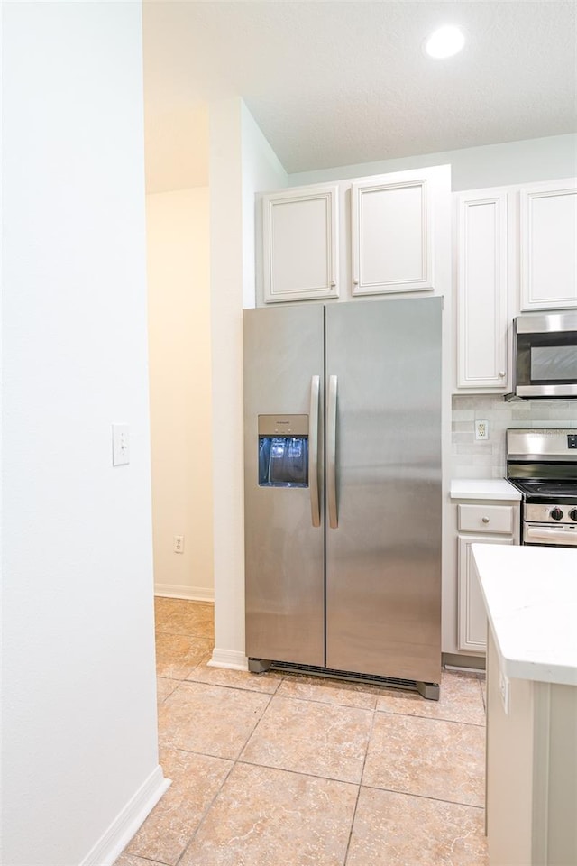 10605 Marsanne Pl, Riverview, FL 33578 - kitchen featuring stainless steel appliances, light countertops, light tile patterned floors, white cabinets, and recessed lighting