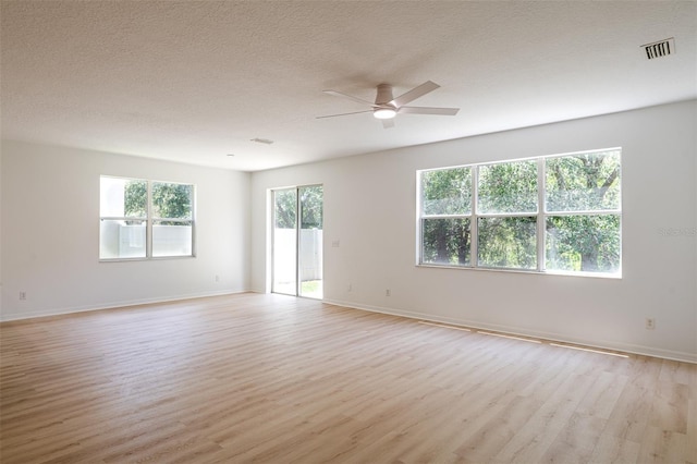 10605 Marsanne Pl, Riverview, FL 33578 - empty room with ceiling fan, light wood finished floors, and a textured ceiling