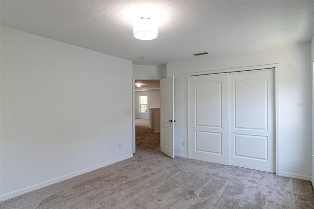 10605 Marsanne Pl, Riverview, FL 33578 - unfurnished bedroom featuring carpet flooring, a textured ceiling, and a closet