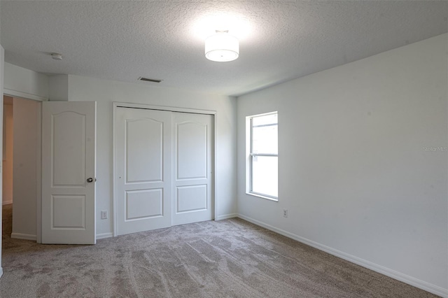10605 Marsanne Pl, Riverview, FL 33578 - unfurnished bedroom featuring a closet, a textured ceiling, and carpet