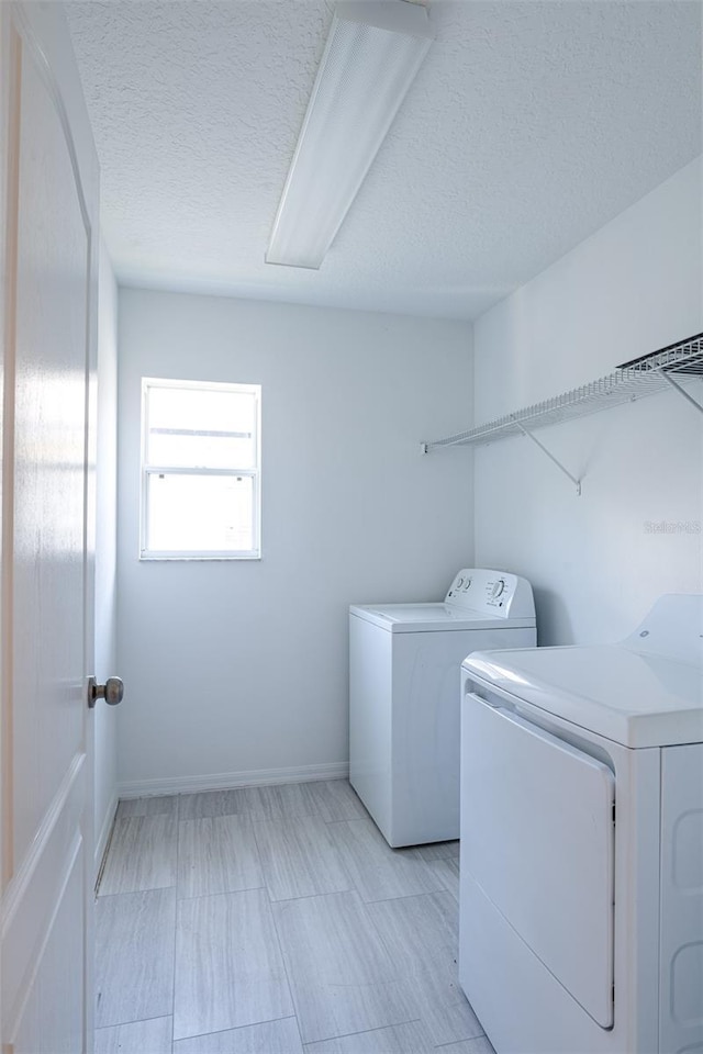 10605 Marsanne Pl, Riverview, FL 33578 - washroom with washing machine and dryer and a textured ceiling