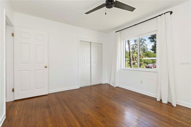 2834 10th Ave N, Saint Petersburg, FL 33713 - unfurnished bedroom with dark wood-style flooring, a closet, and ceiling fan