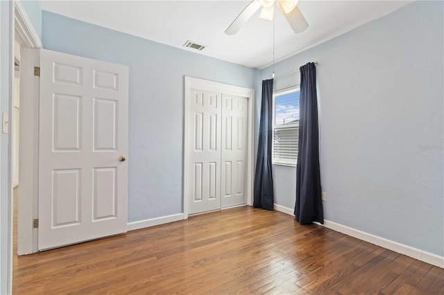 2834 10th Ave N, Saint Petersburg, FL 33713 - unfurnished bedroom featuring wood finished floors, a closet, and a ceiling fan