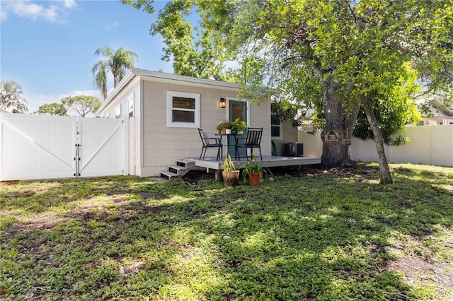 2834 10th Ave N, Saint Petersburg, FL 33713 - back of property featuring a wooden deck, a fenced backyard, and a gate
