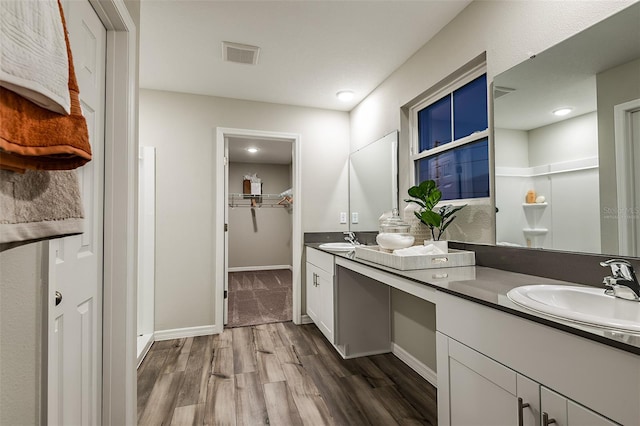 14819 Summer Branch Dr, Lithia, FL 33547 - full bath with double vanity, wood finished floors, a spacious closet, a stall shower, and recessed lighting