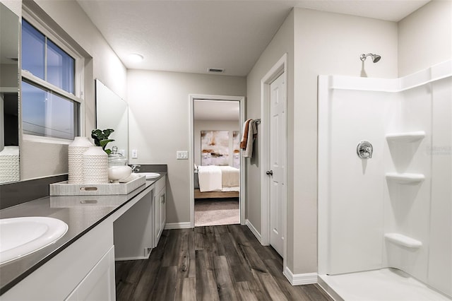 14819 Summer Branch Dr, Lithia, FL 33547 - ensuite bathroom featuring double vanity, wood finished floors, and a shower