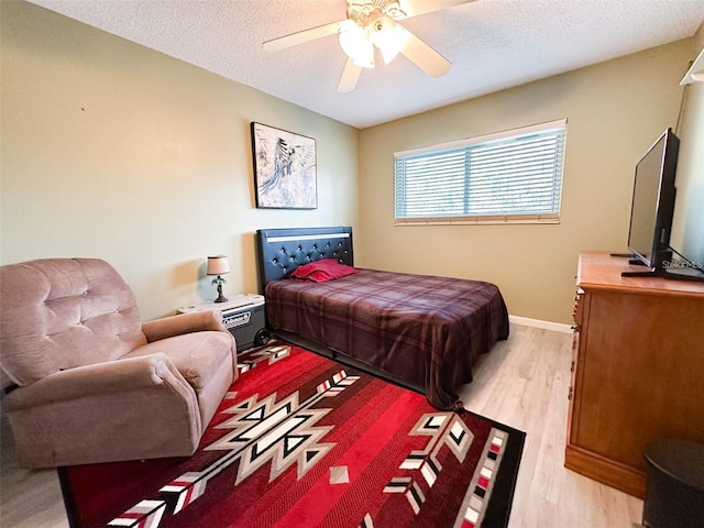 2330 Ecuadorian Way Unit 30, Clearwater, FL 33763 - bedroom featuring light wood-type flooring, a textured ceiling, and a ceiling fan