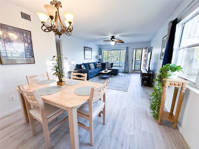 2330 Ecuadorian Way Unit 30, Clearwater, FL 33763 - dining space with light wood-style flooring, a ceiling fan, and a chandelier