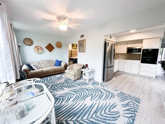 2330 Ecuadorian Way Unit 30, Clearwater, FL 33763 - living area with light wood-style flooring and ceiling fan