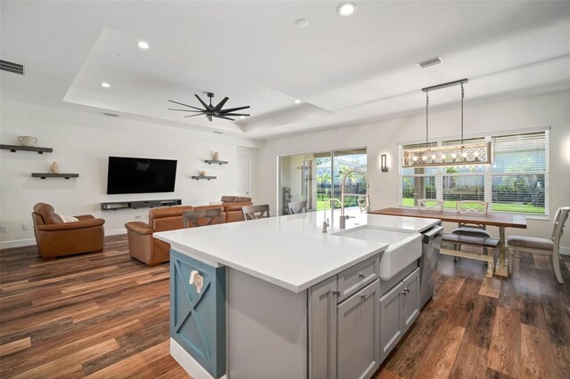 3326 Acacia Bay Ave, Wesley Chapel, FL 33543 - kitchen with gray cabinets, a tray ceiling, stainless steel dishwasher, dark wood-style floors, and recessed lighting